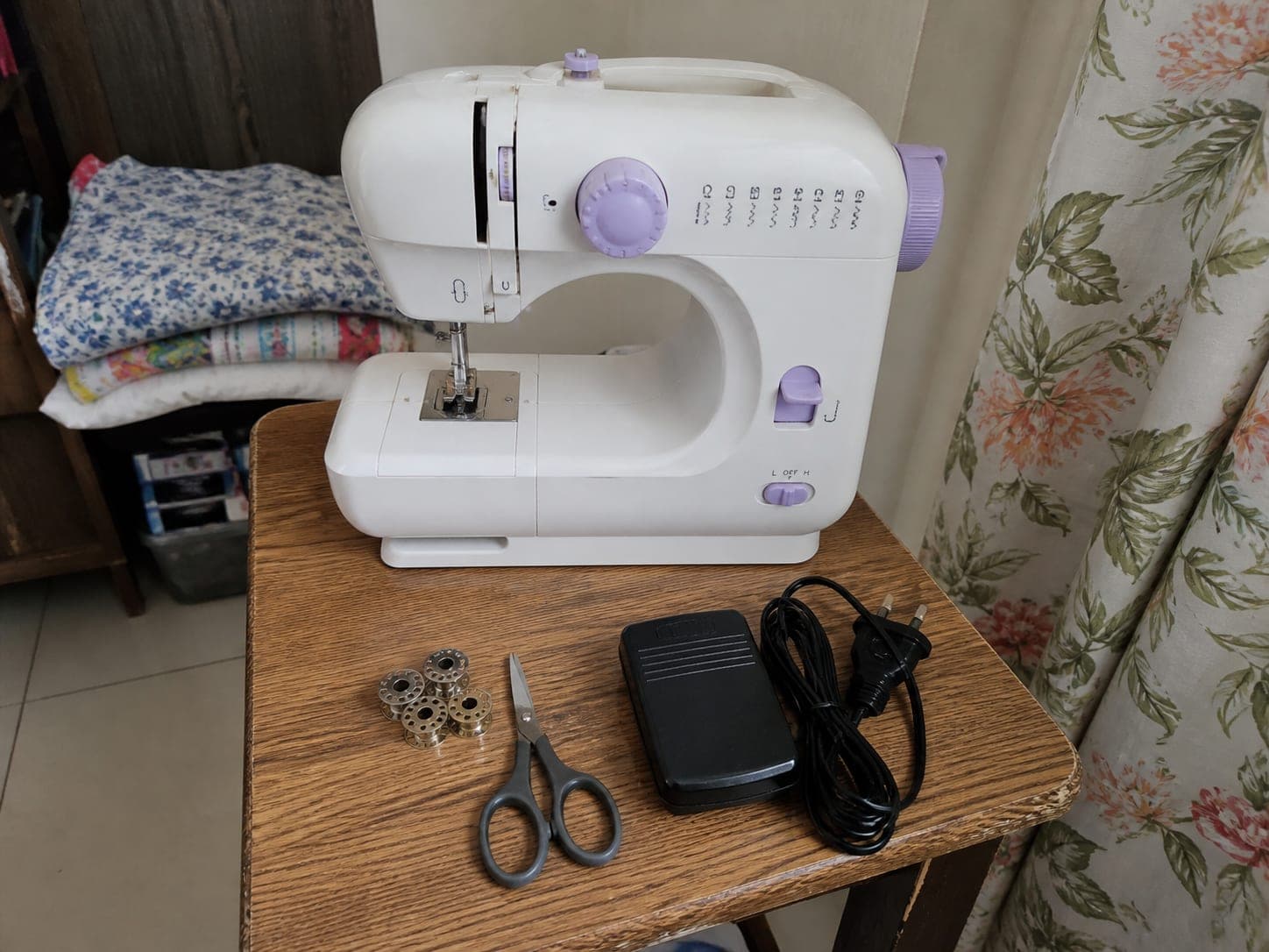 Portable sewing machine with foot pedal